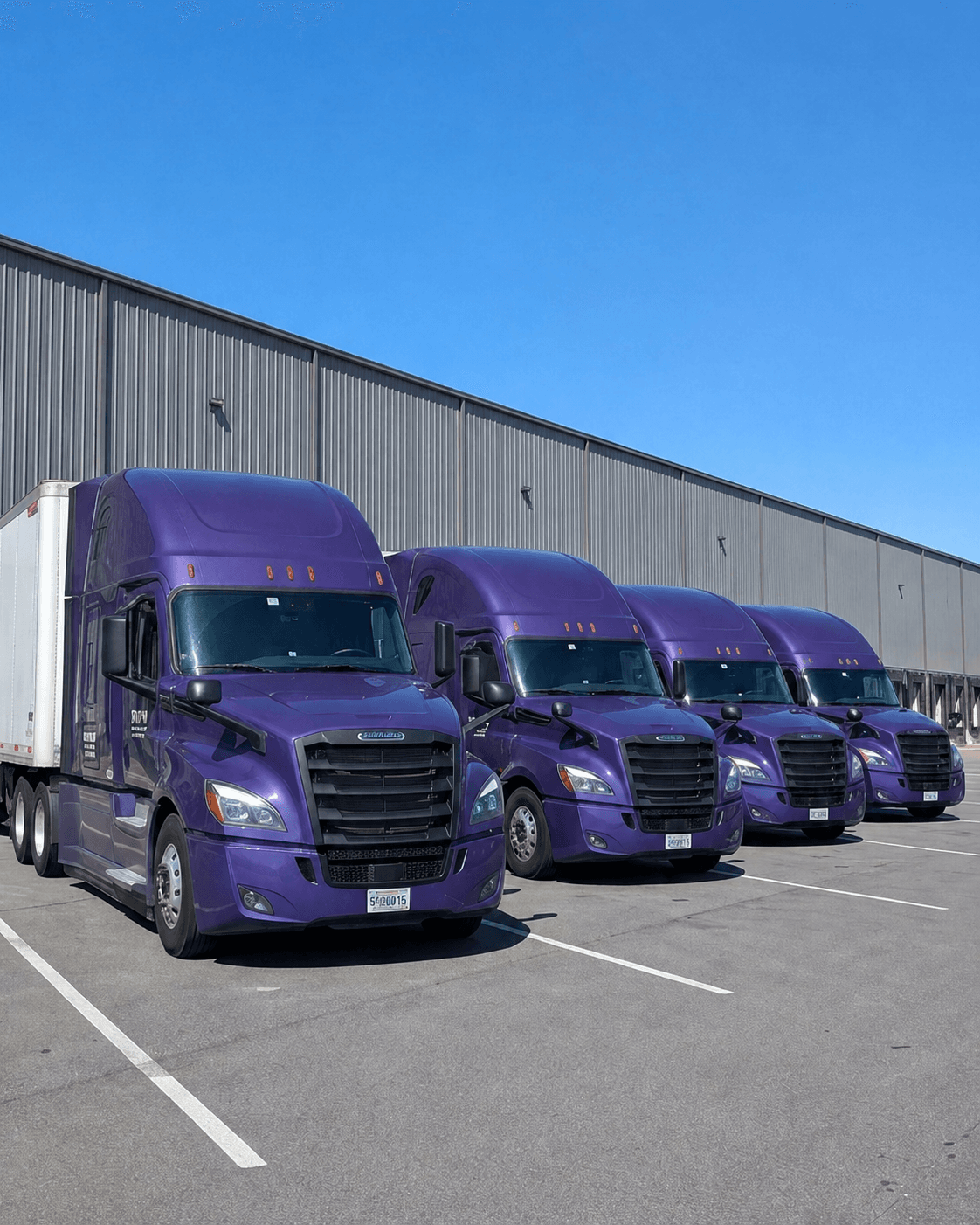 Fleet of Yopo Expedite trucks parked at the distribution yard